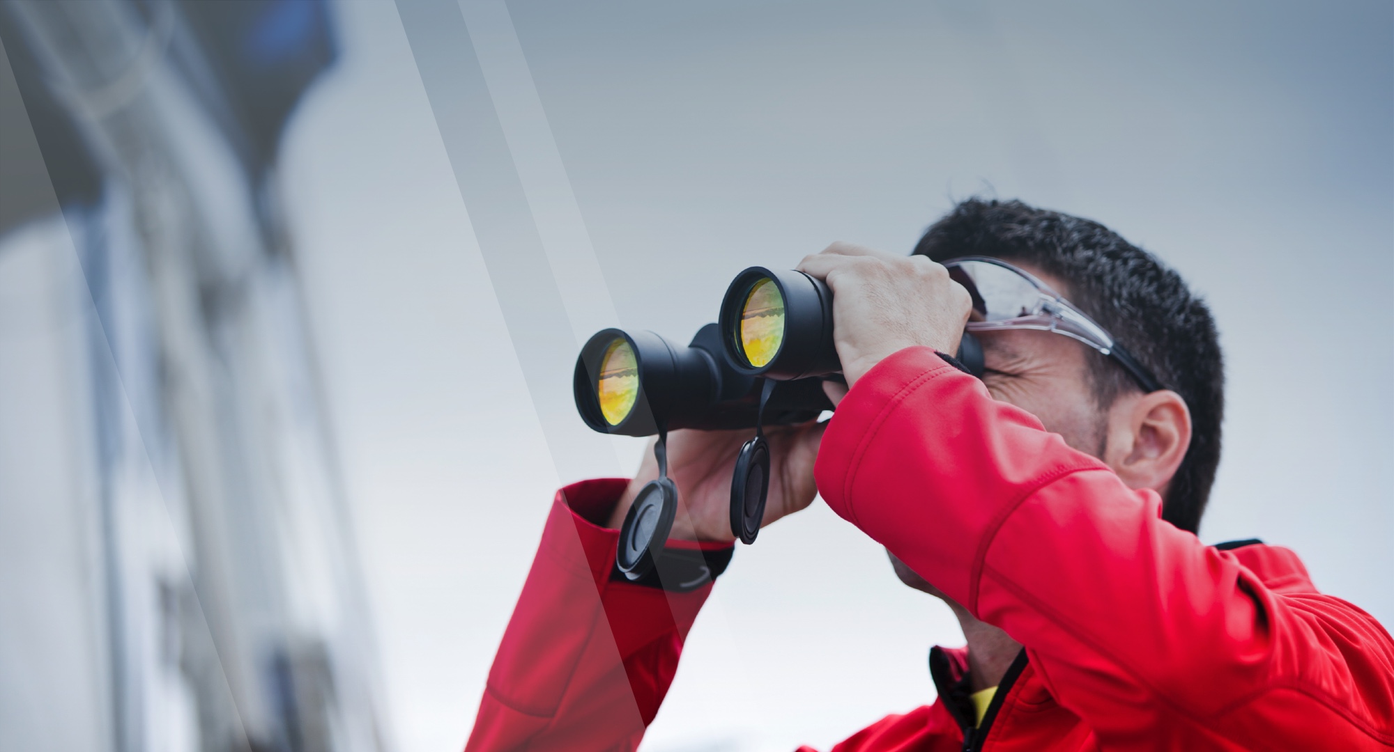 Man using binoculars banner for the Terms of Service page on US Captains License.